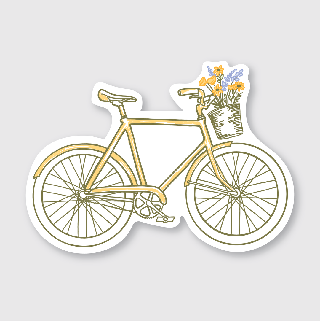 Illustration of a bike sticker showcasing a yellow bicycle with a wicker basket on the handlebars, filled with vibrant flowers. This delightful design adds a whimsical touch to any plain white background.