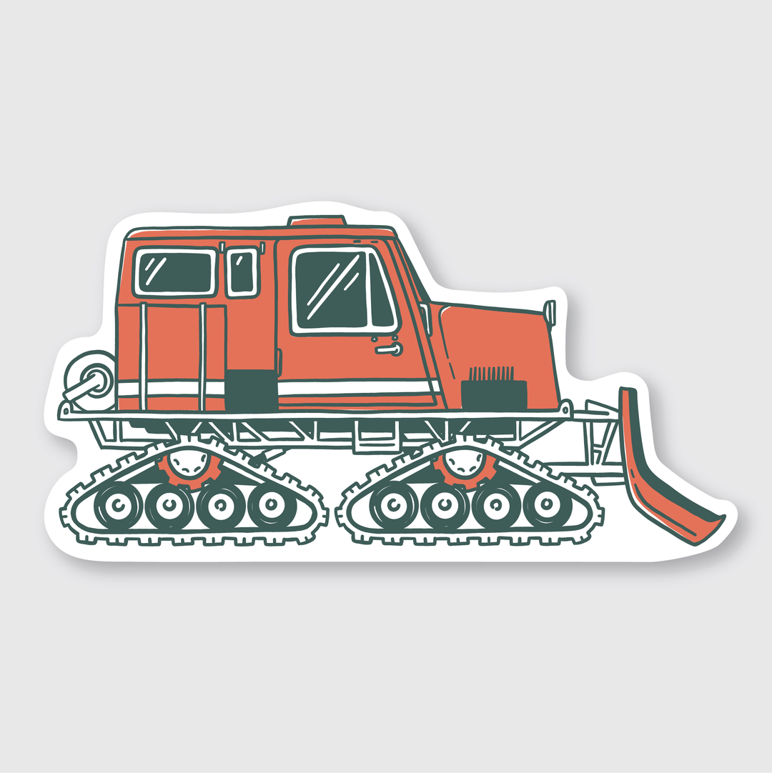 The description depicts a sticker featuring a cartoon-style snowcat vehicle in red and white, equipped with large tracks and a front plow, designed for navigating snowy landscapes. The image is presented against a simple gray background with bold lines, making it suitable for die-cut vinyl application.