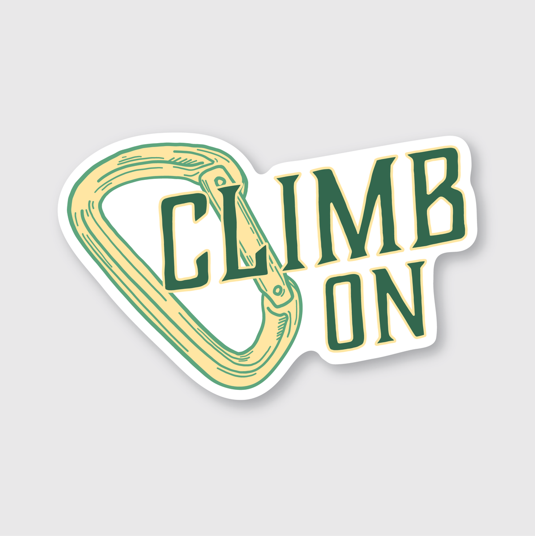 The image showcases an outdoor-themed sticker designed for adventure enthusiasts. The sticker features a climbing carabiner set against a white background, with the phrase "CLIMB ON" in bold, green lettering. Crafted from durable vinyl material, it’s suitable for outdoor use and reflects a spirit of motivation and adventure. This item is meticulously made in Seattle, symbolizing a community passionate about climbing and exploration.